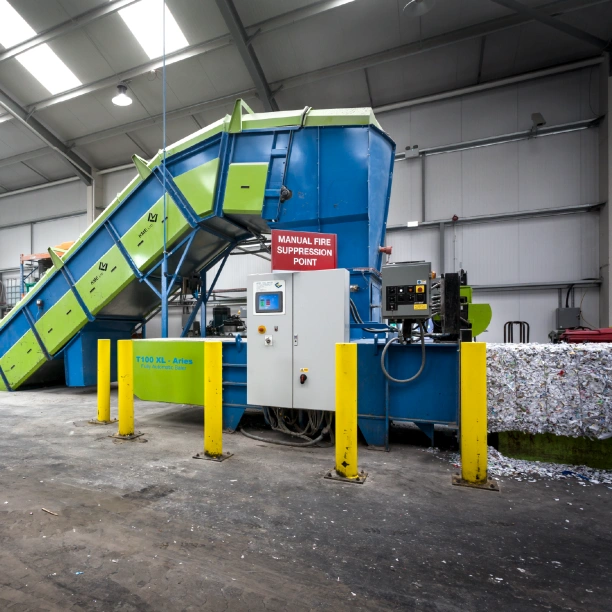 An industrial baling machine inside one of Shred Station's secure depots