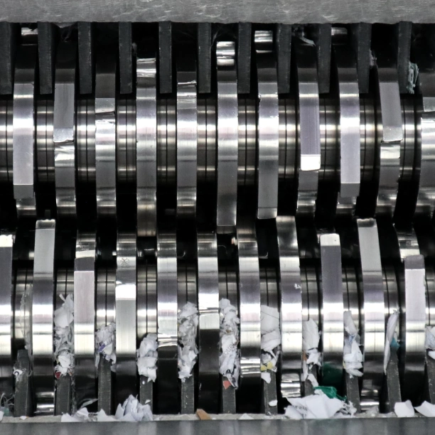 The metal blades of an industrial on-site shredding machine.