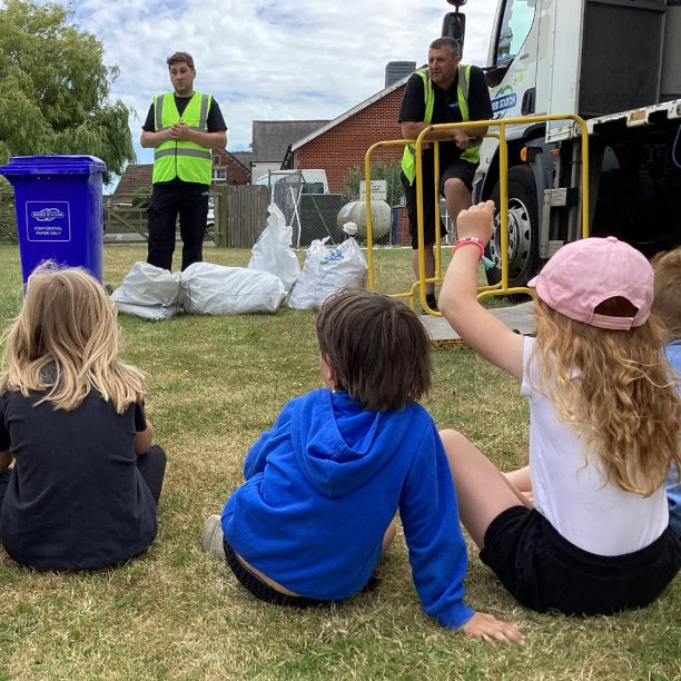Shred Station employees doing a demonstration at a primary school.