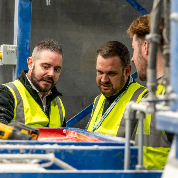 Operatives inspecting a piece of machinery.