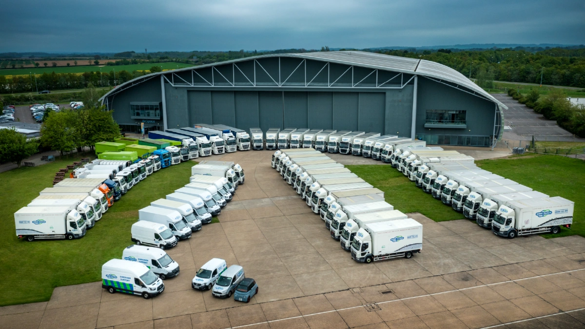 A large number of trucks from aerial view, in arch formation.