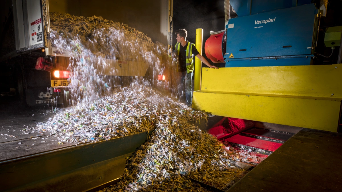 Paperwork being unloaded from an on-site shredding truck.