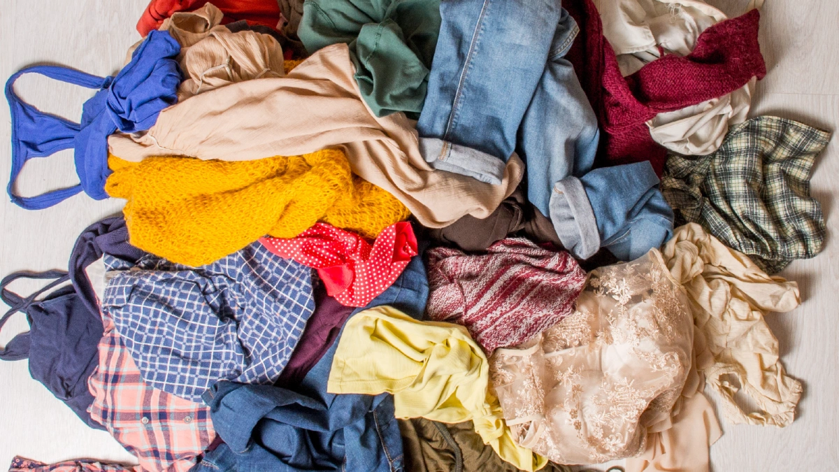 Pile of clothing items in the middle of a floor.