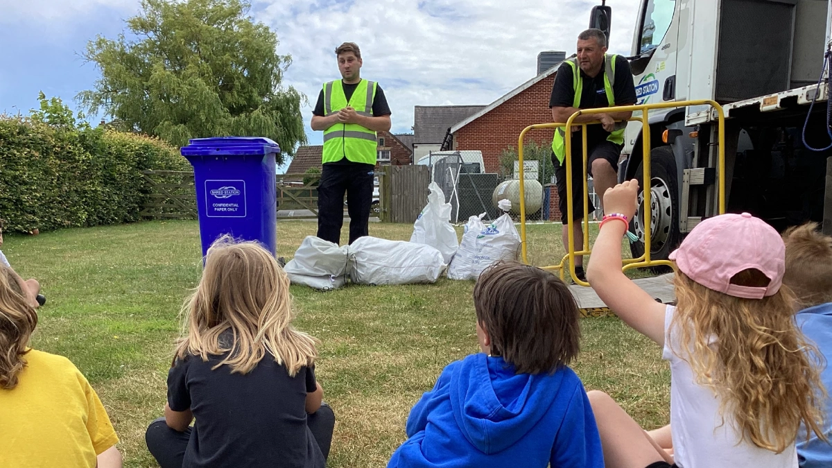 Shred Station staff talking to children at a local primary school.