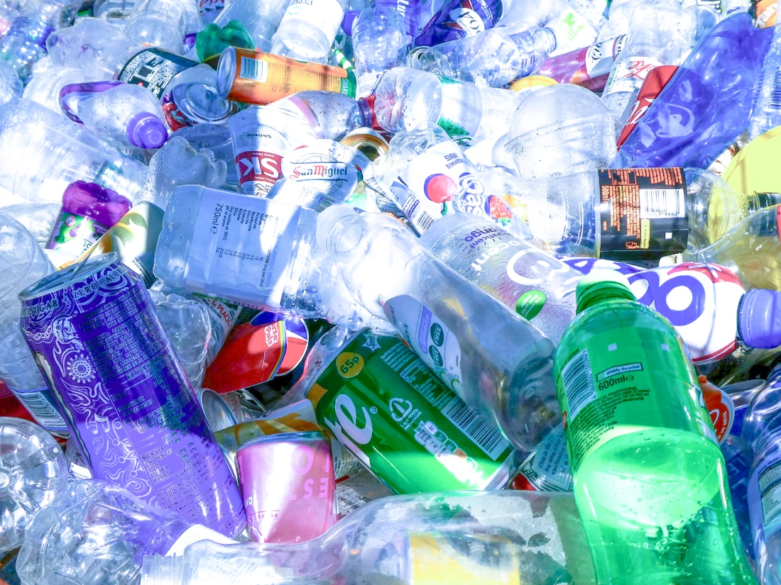 Pile of empty waste plastic bottles and cans.