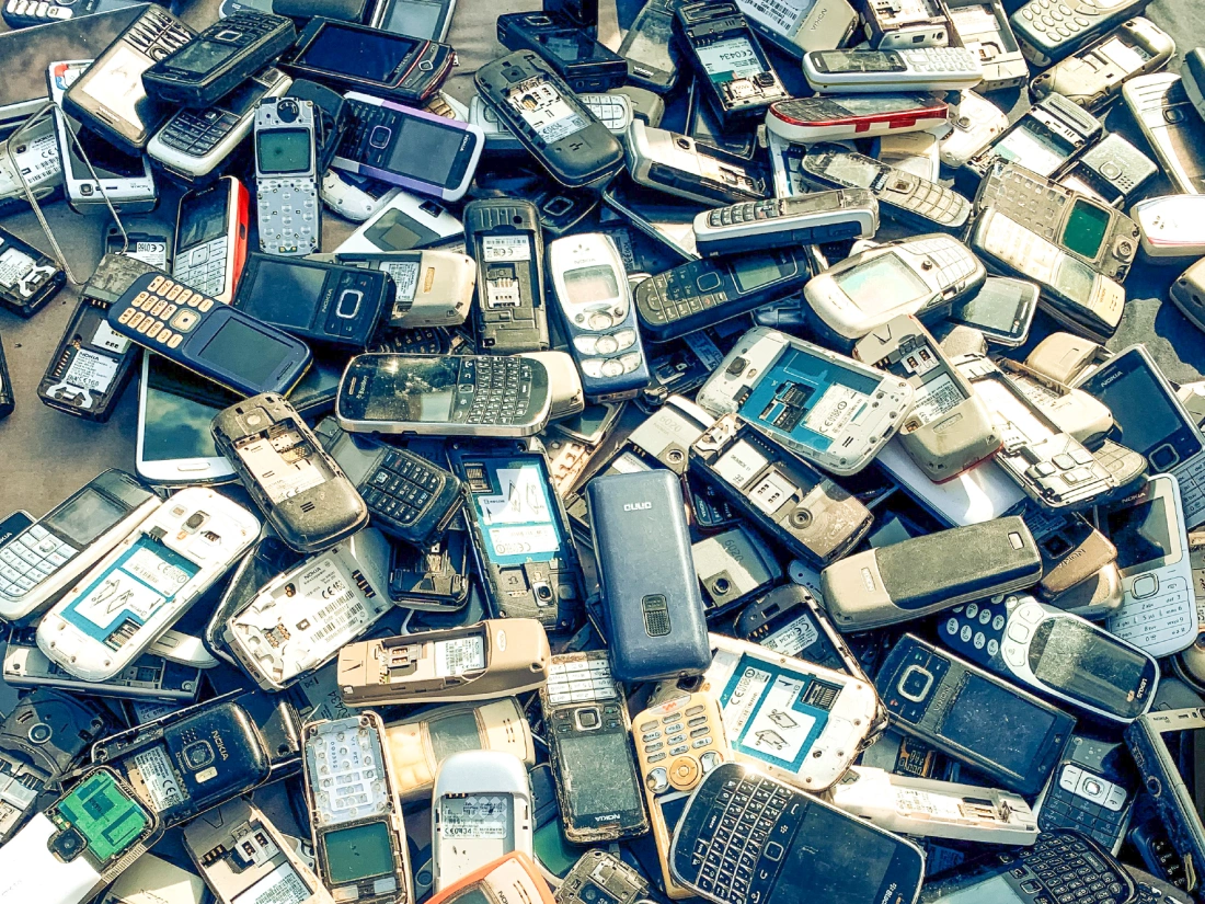 Large pile of old discarded mobile phones.