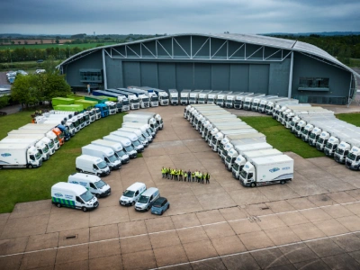 Shred Station's leaders standing in front of vehicle fleet.