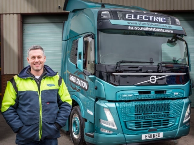 Simon Franklin - Shred Station's founder and Managing Director - standing in front of electric articulated lorry.