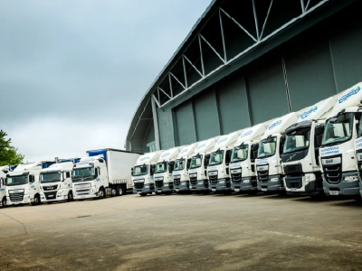 Shred Station trucks lined up outside a large building.