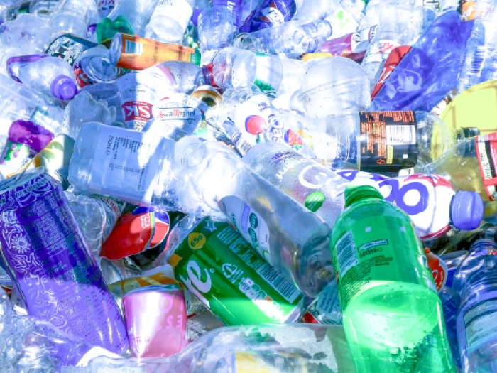 Pile of empty waste plastic bottles and cans.