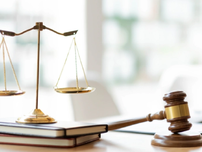 The scales of justice and gavel on a desk.