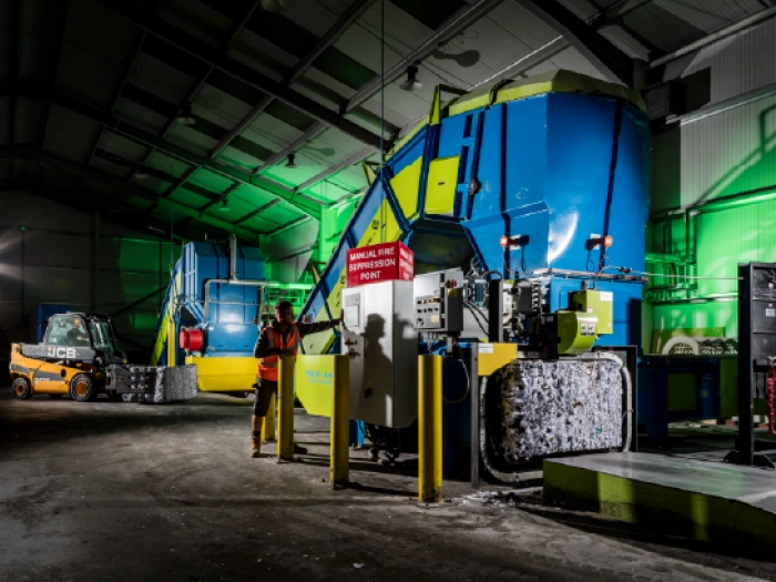 An industrial shredding machine and paper baler at one of Shred Station's secure facilities.