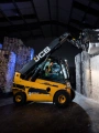 Forklift moving a bale of shredded compressed paperwork.