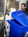 Shred Station operative emptying confidential waste into a shredder.