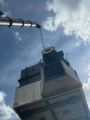 A crane moving a large piece of machinery.