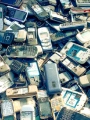 Large pile of old discarded mobile phones.