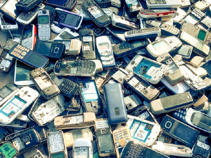 Large pile of old discarded mobile phones.