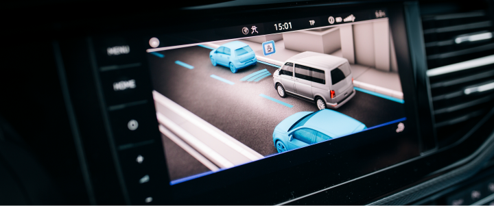 A screen on the inside of a car showing parking assistance software