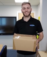 Image of Shred Station staff member holding a box of waste paperwork