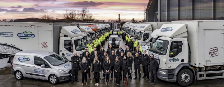 Image of Shred Station staff and large fleet of shredding trucks