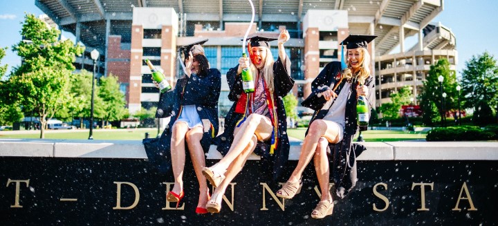 Image of three newly graduated females celebrating