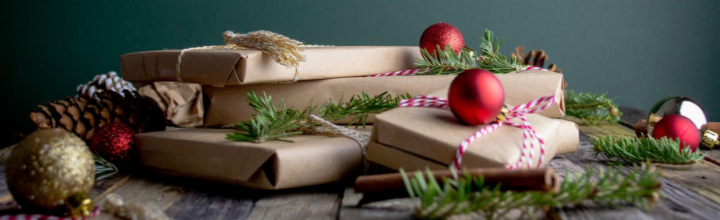 Image of presents wrapped in brown recyclable wrapping paper with string and pine