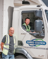 Image of two men with a shredding truck