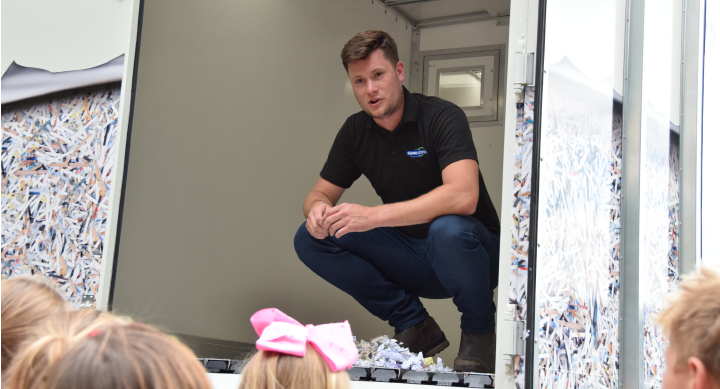 Image of Shred Station's Operations Director, Oliver Grice, teaching children about paper shredding and information security.