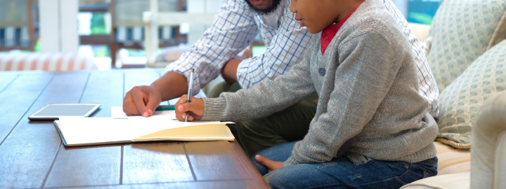 Image of father helping his son with somework