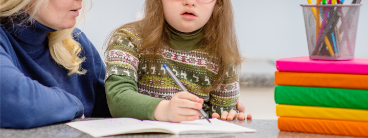 Image of child writing in book