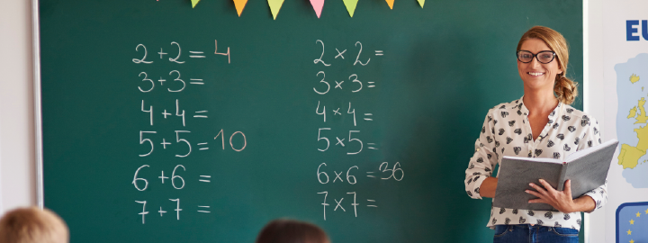 Image of teacher in front of board