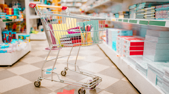 Image of shopping cart in stationery aisle.
